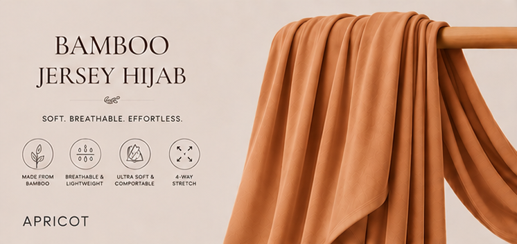 Apricot bamboo jersey hijab on a wooden rod with product features listed.