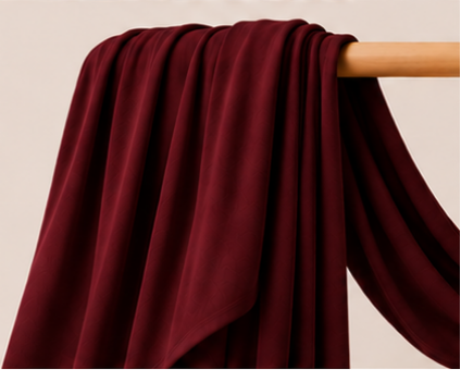 Burgundy bamboo jersey hijab on a wooden stick with product features listed.