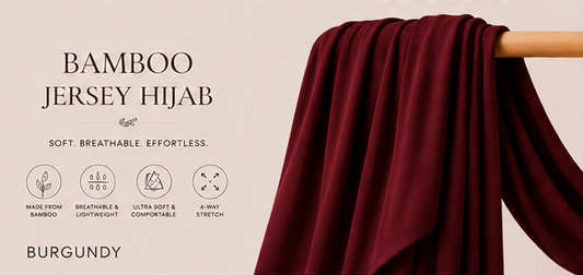 Burgundy bamboo jersey hijab on a wooden stick with product features listed.