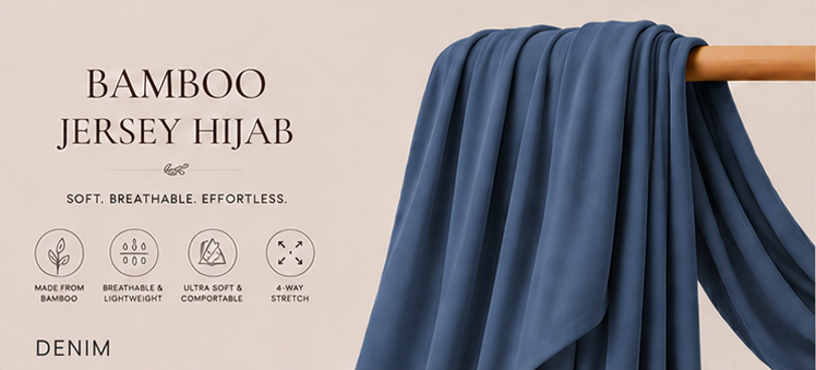 Silver Bamboo Jersey Islamic Hijab And Scarf fabric draped over a wooden rod against a beige background