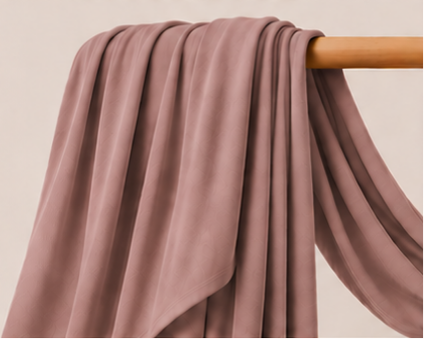 Bamboo jersey hijab in dusty mauve color on a wooden rod with product features listed.
