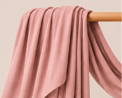 Dusty pink bamboo jersey hijab on a wooden rod with product features listed.