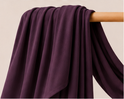 Eggplant purple bamboo jersey hijab on a wooden stick with product features listed.