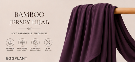Eggplant purple bamboo jersey hijab on a wooden stick with product features listed.