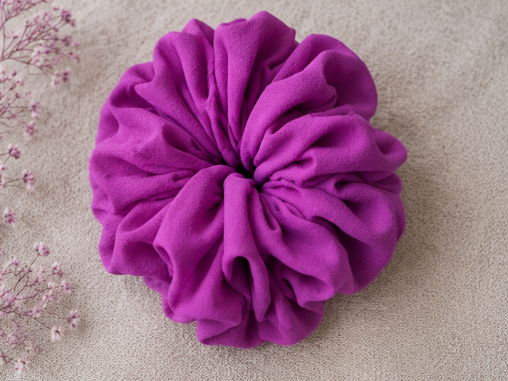 Purple Lavender scrunchie on a beige background with pink flowers