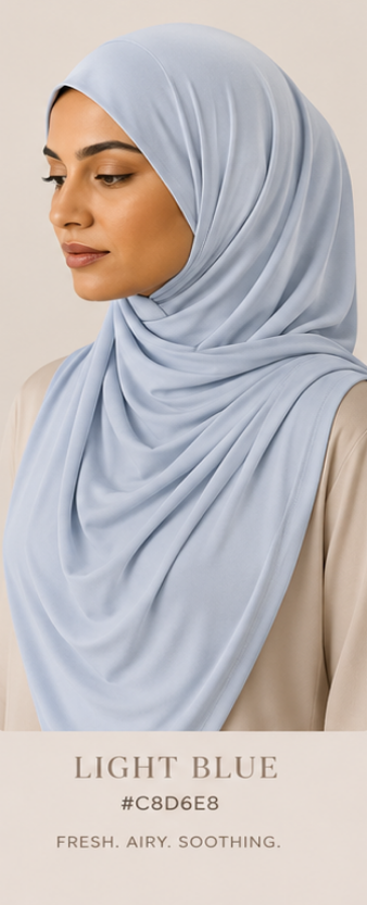 Woman wearing a light blue luxe jersey hijab with color code and description text overlay.