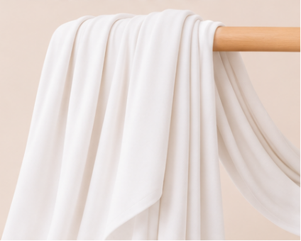 Milky White bamboo jersey hijab on a wooden rod with product features listed.