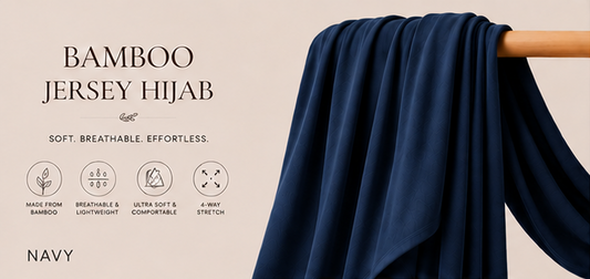 Navy Blue bamboo jersey hijab on a wooden rod with product details on a beige background