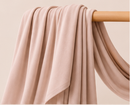 Nude bamboo jersey hijab on a wooden rod with product features listed.
