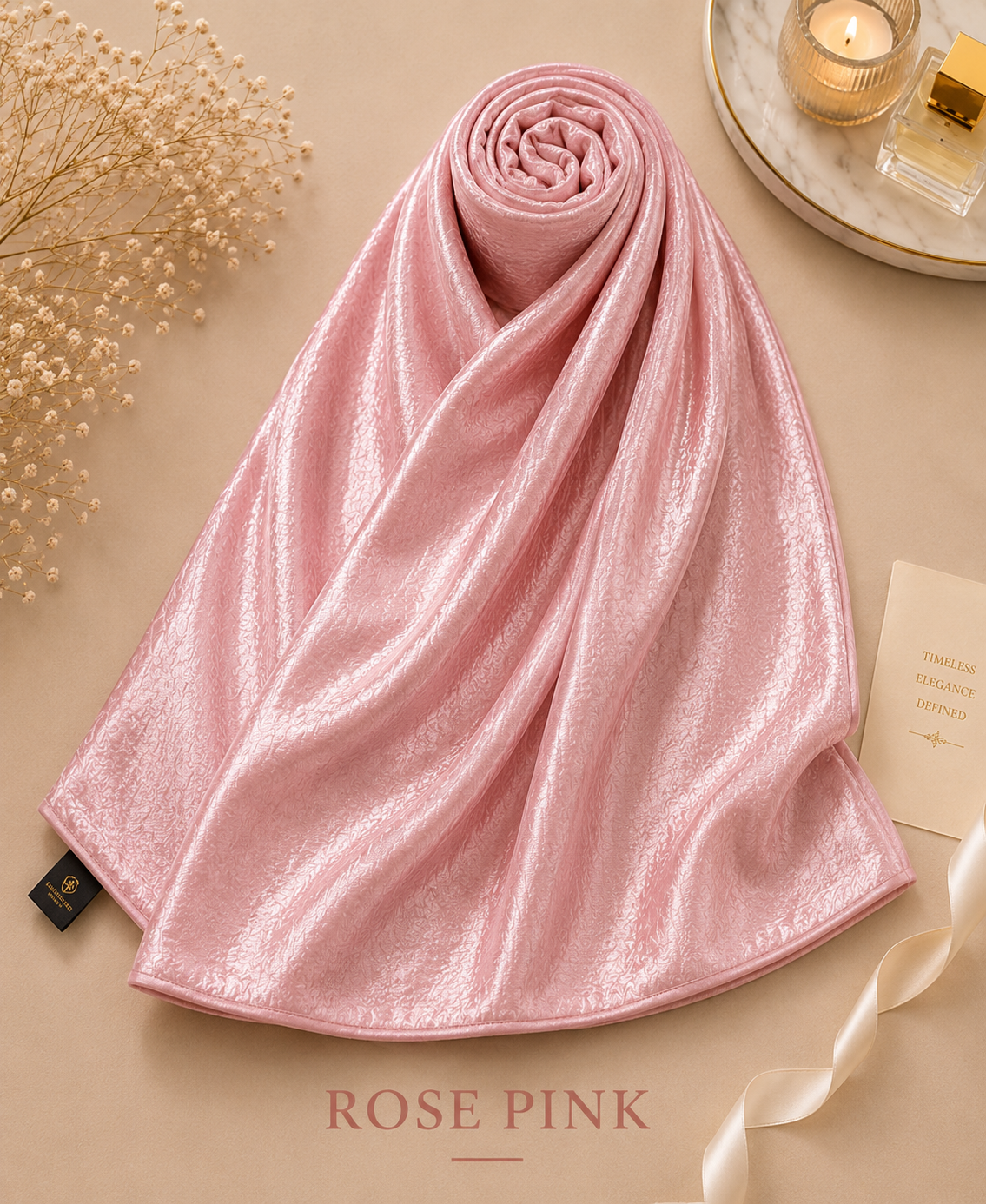 Rose pink Bubble Satin Islamic Hijab Scarf on a beige surface with decorative elements